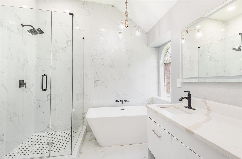 3674 Crowberry Way Fort Worth, TX 76040 - Photo 20 of 26 Bathroom with marble tiled flooring, a freestanding tub, a marble finish shower, vanity, and vaulted ceiling