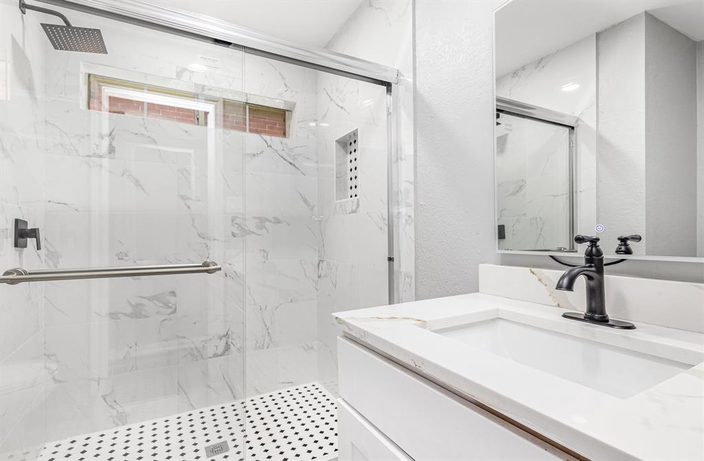 3674 Crowberry Way Fort Worth, TX 76040 - Photo 25 of 26 Bathroom with vanity, a marble finish shower, and a textured wall