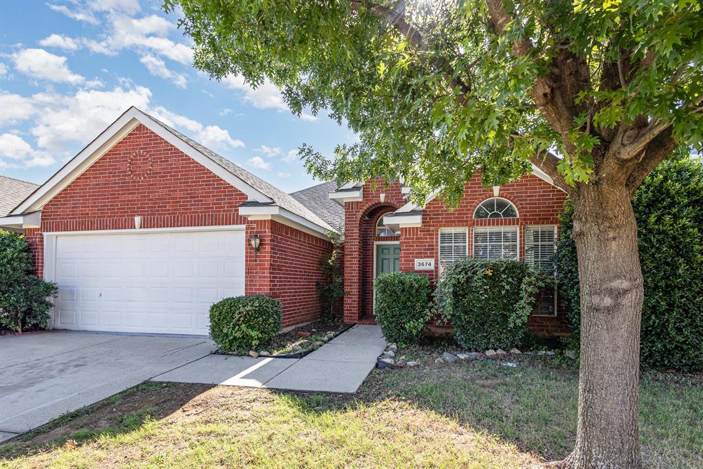 3674 Crowberry Way Fort Worth, TX 76040 - Photo 3 of 26 Traditional home with brick siding, roof with shingles, a garage, and concrete driveway