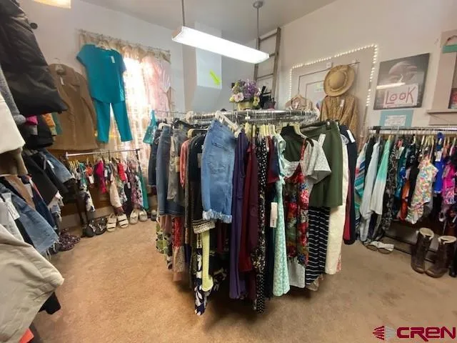 a view of walk in closet with clothes