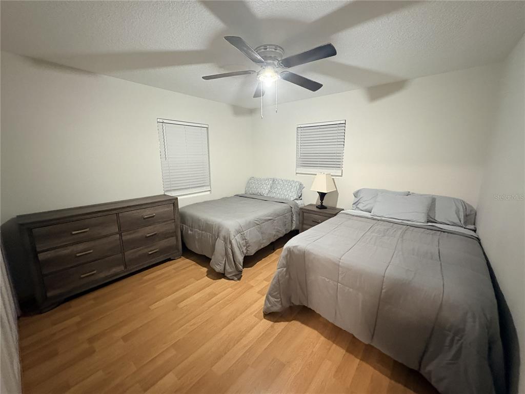 6693 Engram Road New Smyrna Beach, FL 32169 - Photo 6 of 18 a bedroom with two beds and painting on the wall