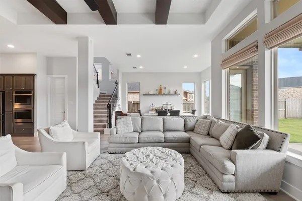 a living room with furniture and kitchen view