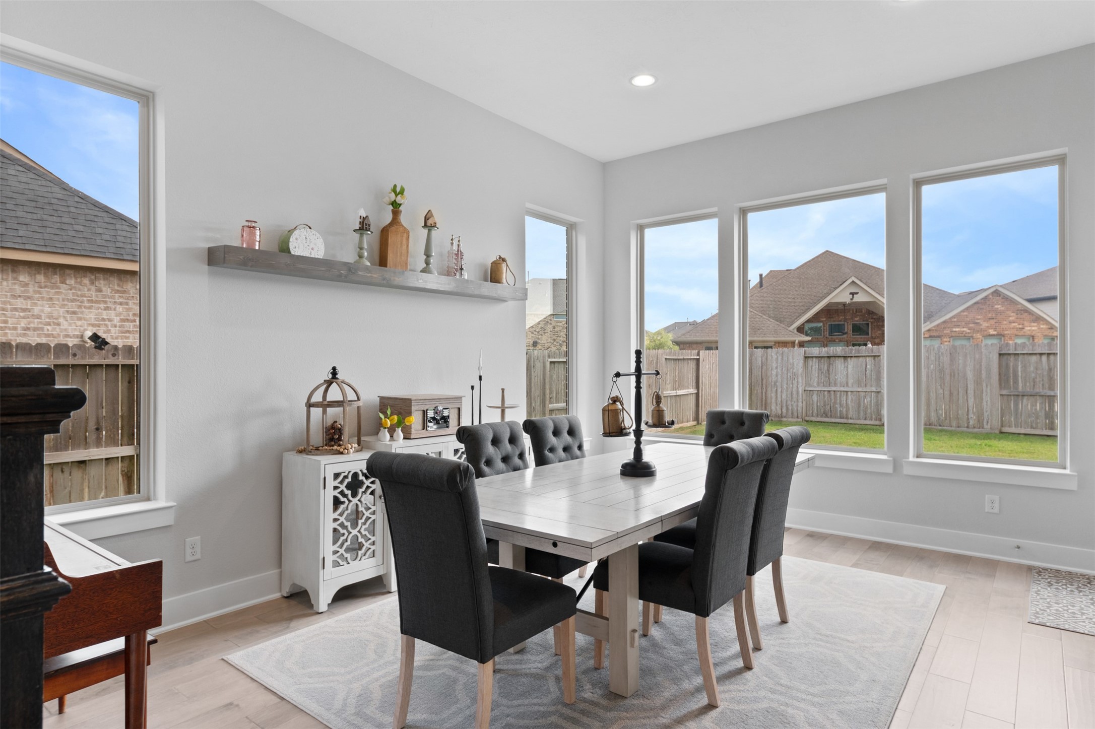 1102 McMurtry Ridge Drive Katy, TX 77494 - Photo 17 of 41 a view of a dining room with furniture large windows and wooden floor