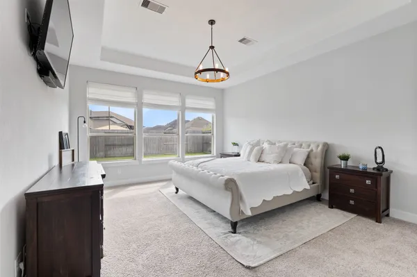 a spacious bathroom with a granite countertop sink toilet a large mirror a bathtub and shower
