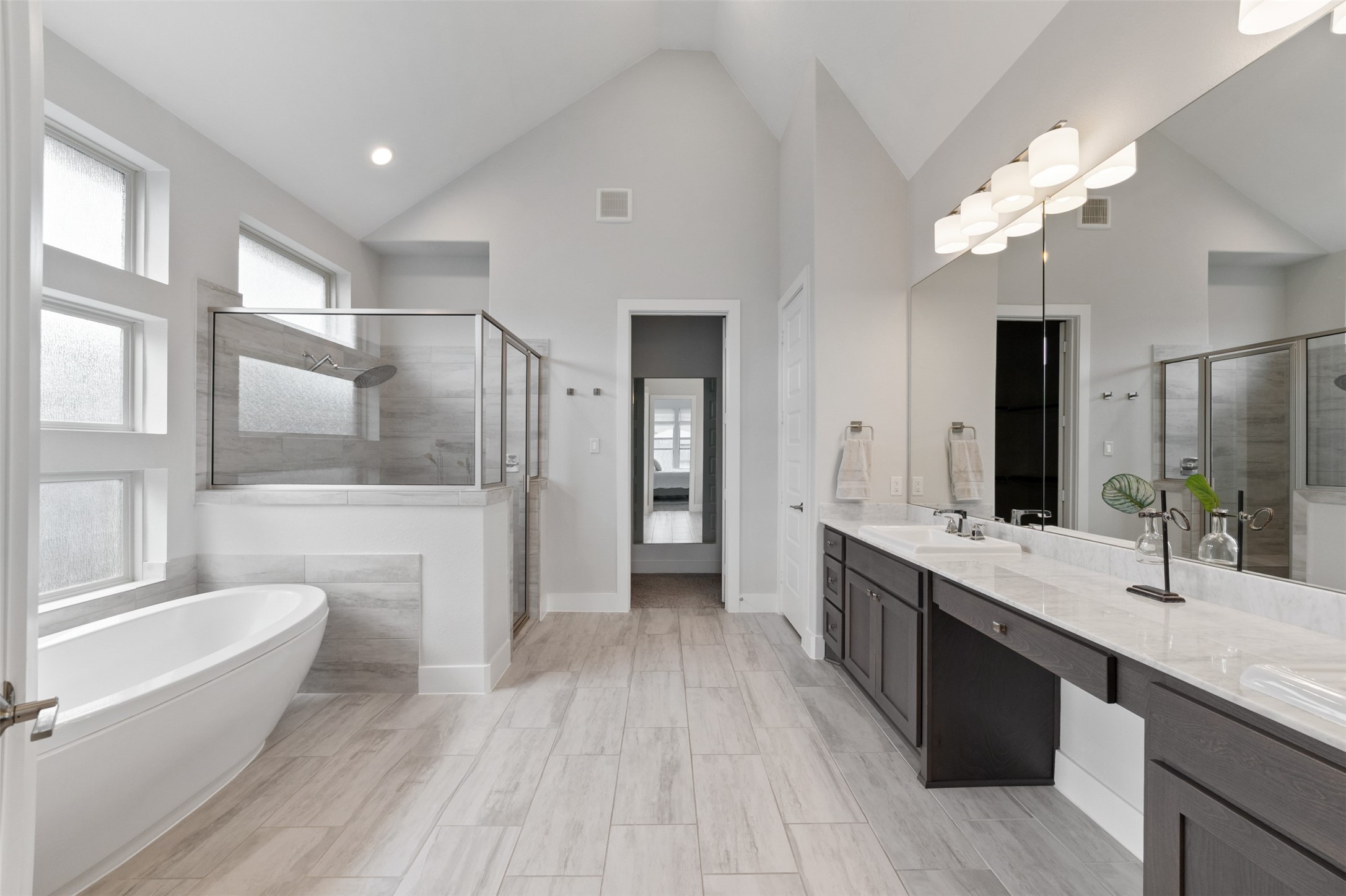 1102 McMurtry Ridge Drive Katy, TX 77494 - Photo 21 of 41 a spacious bathroom with a granite countertop sink toilet a large mirror a bathtub and shower