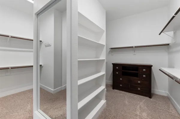 a bedroom with a bed and a chair