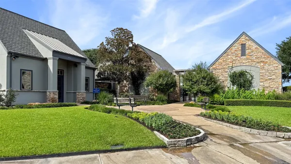 a front view of a house with garden and porch