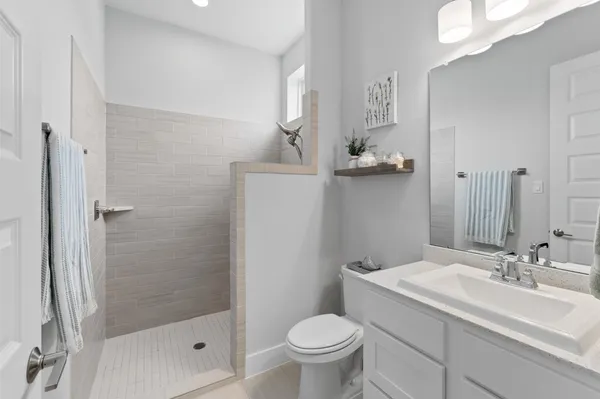 a bathroom with a sink toilet and shower