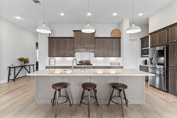 a large kitchen with a table and chairs in it