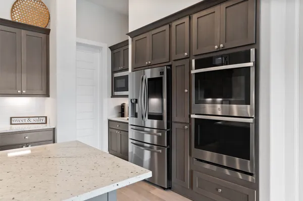 a kitchen with granite countertop stainless steel appliances and wooden cabinets