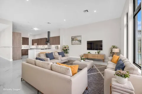 a view of kitchen with white cabinets and wooden floor