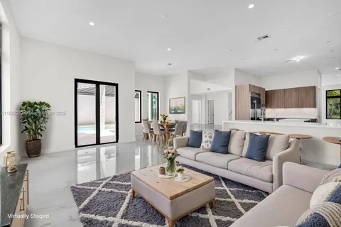 a large white kitchen with a large window