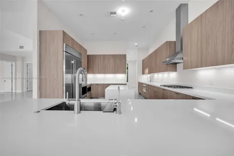 a kitchen with a refrigerator and a sink