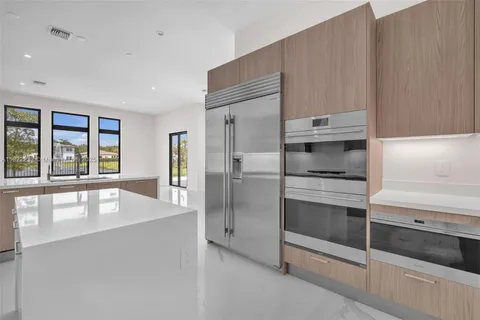 a kitchen with a sink a stove and refrigerator