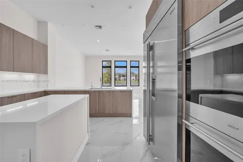 a kitchen with stove and cabinets