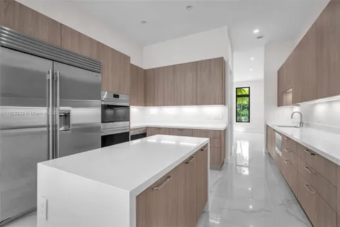 a kitchen with stainless steel appliances granite countertop a sink and a stove