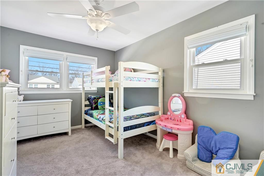 675 Colonial Arms Road Union, NJ 07083 - Photo 14 of 25 a bedroom with a bed and a chandelier