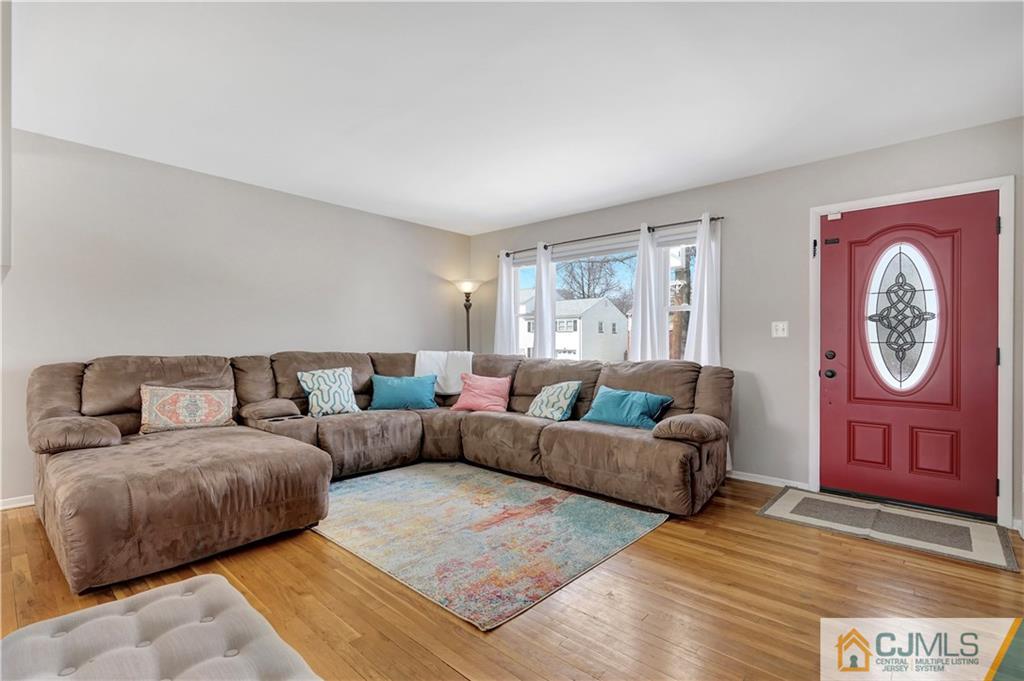 675 Colonial Arms Road Union, NJ 07083 - Photo 4 of 25 a living room with furniture a clock and a window