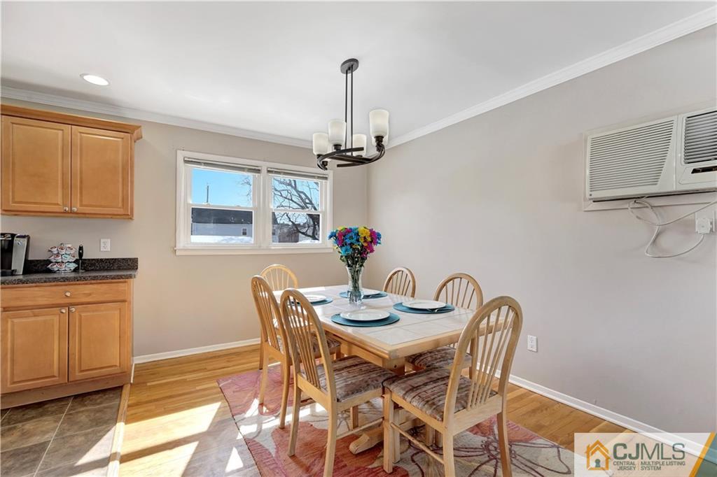 675 Colonial Arms Road Union, NJ 07083 - Photo 7 of 25 a dining room with furniture a chandelier and wooden floor