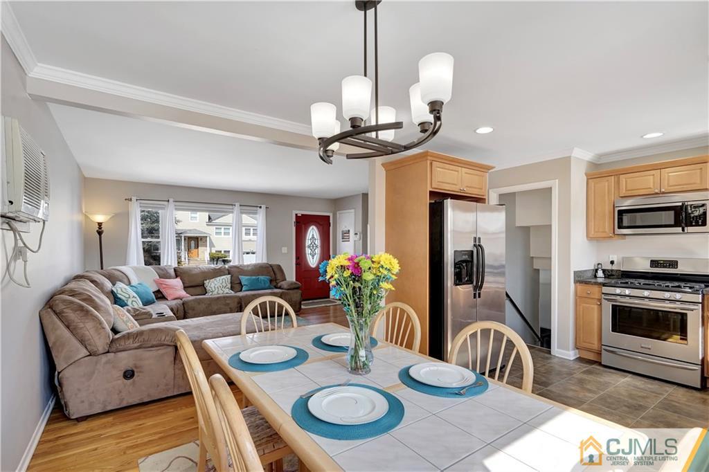 675 Colonial Arms Road Union, NJ 07083 - Photo 8 of 25 a view of a dining room with furniture a chandelier and wooden floor