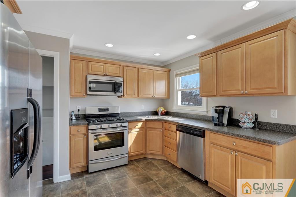 675 Colonial Arms Road Union, NJ 07083 - Photo 10 of 25 a kitchen with stainless steel appliances granite countertop a stove a sink and a microwave