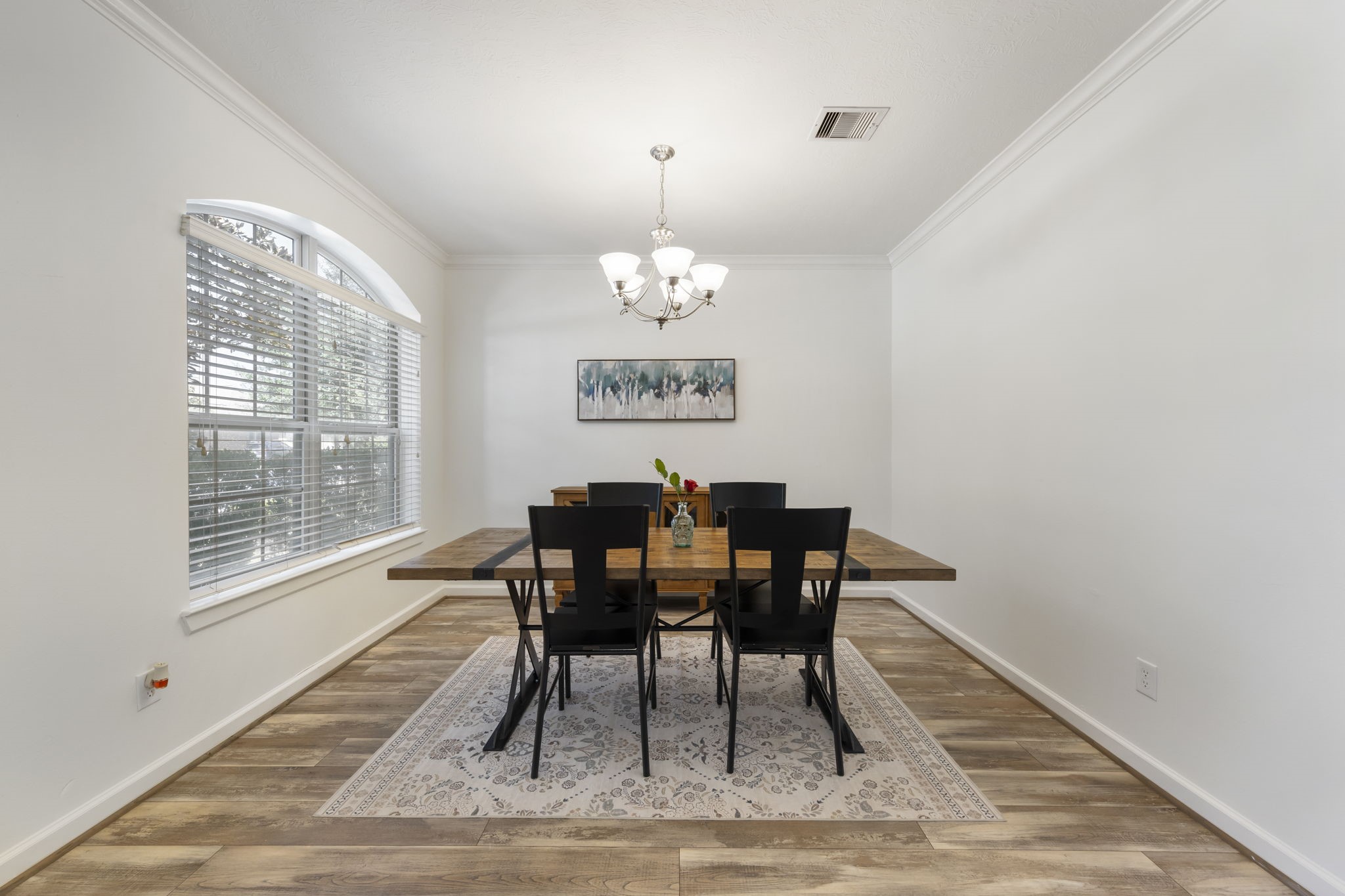 3318 Solvista High Court Spring, TX 77386 - Photo 6 of 33 Elegant dining room with lots of natural light, an oversized arched window, crown molding, and the perfect setting for intimate dinners or effortless entertaining.