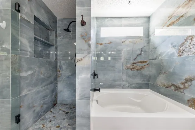 a bathroom with a bathtub and shower