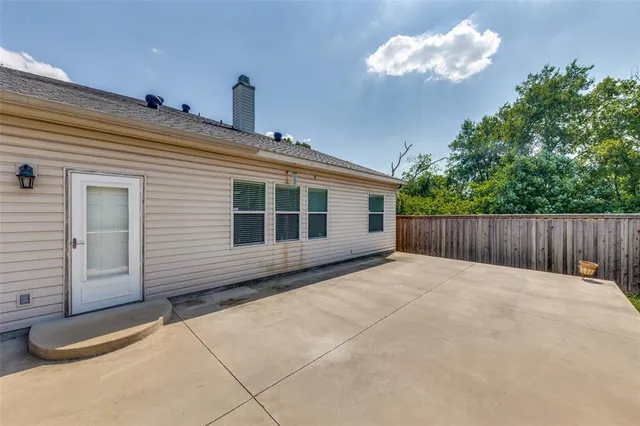a balcony with view of the backyard