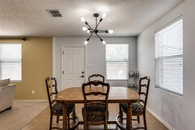 a view of a a dining room with furniture window and outside view