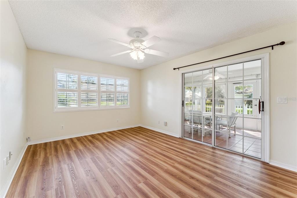 27217 Racquet Circle Leesburg, FL 34748 - Photo 15 of 90 a view of an empty room with wooden floor and a window