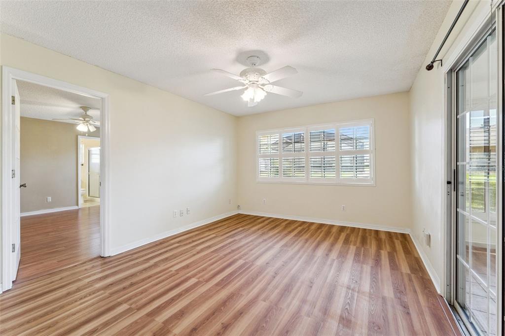 27217 Racquet Circle Leesburg, FL 34748 - Photo 16 of 90 wooden floor in an empty room with a window
