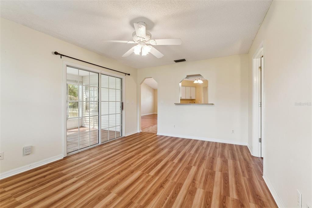 27217 Racquet Circle Leesburg, FL 34748 - Photo 17 of 90 a view of empty room with wooden floor and fan