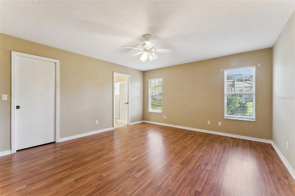 27217 Racquet Circle Leesburg, FL 34748 - Photo 18 of 90 wooden floor in an empty room with a window