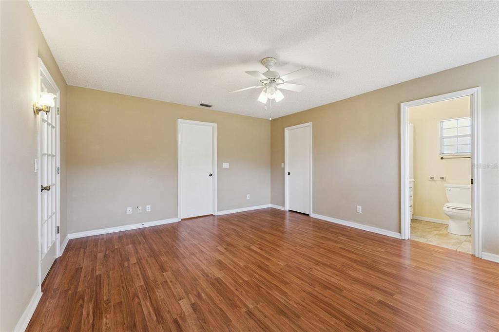 27217 Racquet Circle Leesburg, FL 34748 - Photo 20 of 90 a view of an empty room with wooden floor