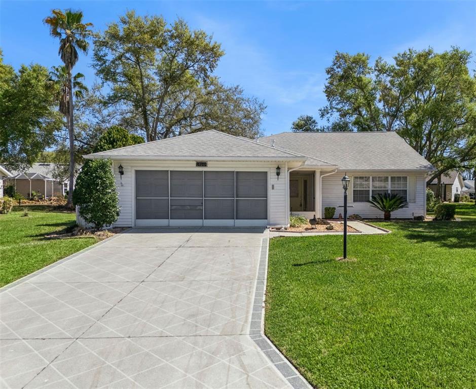 27217 Racquet Circle Leesburg, FL 34748 - Photo 2 of 90 front view of a house with a yard
