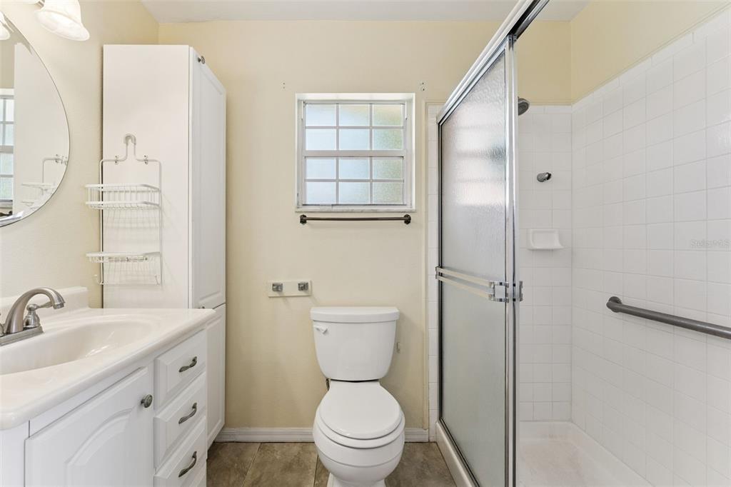 27217 Racquet Circle Leesburg, FL 34748 - Photo 21 of 90 a bathroom with a sink a toilet and shower