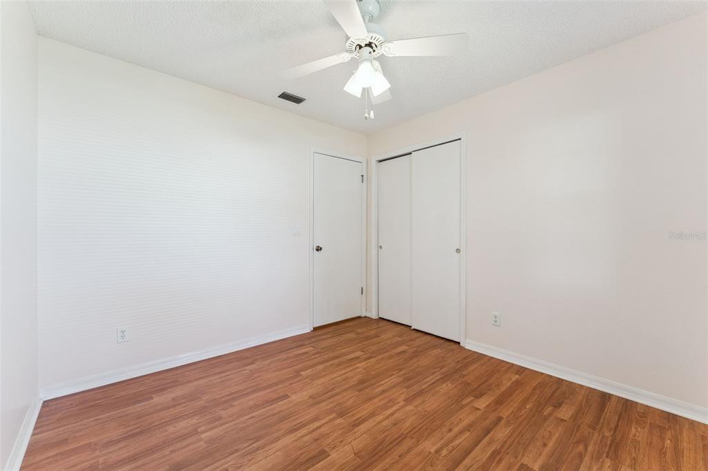 27217 Racquet Circle Leesburg, FL 34748 - Photo 27 of 90 wooden floor in an empty room
