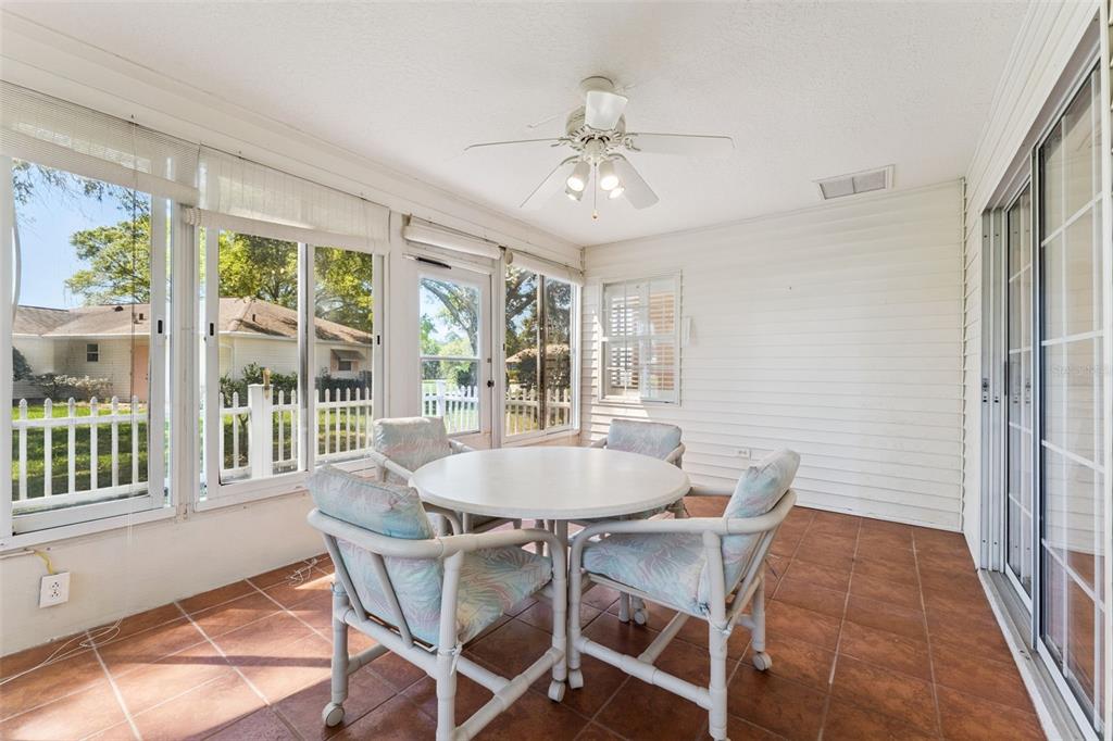 27217 Racquet Circle Leesburg, FL 34748 - Photo 30 of 90 a dining room with furniture a chandelier and wooden floor