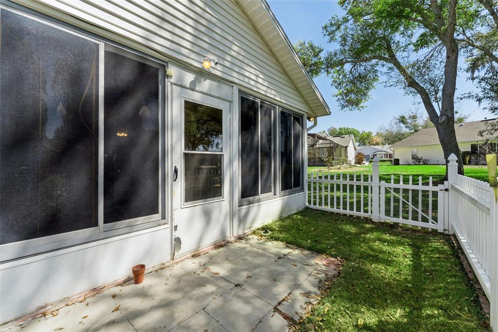 27217 Racquet Circle Leesburg, FL 34748 - Photo 33 of 90 a view of a house with a small yard and wooden fence
