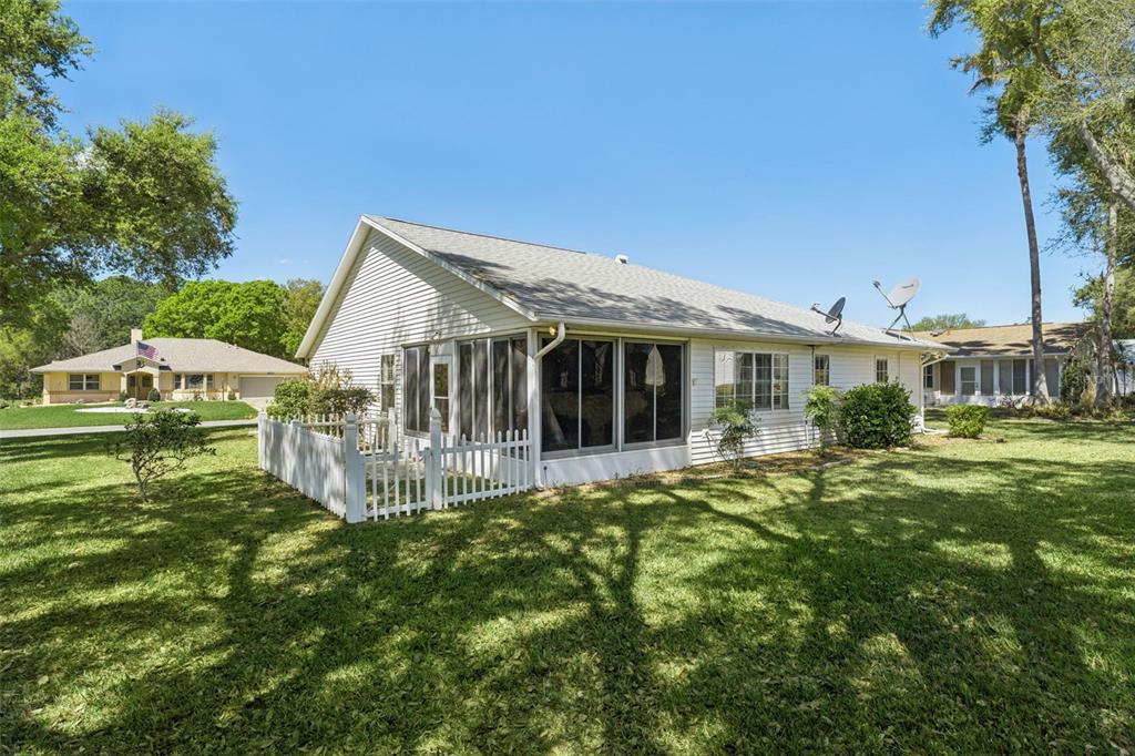 27217 Racquet Circle Leesburg, FL 34748 - Photo 34 of 90 a front view of a house with a garden