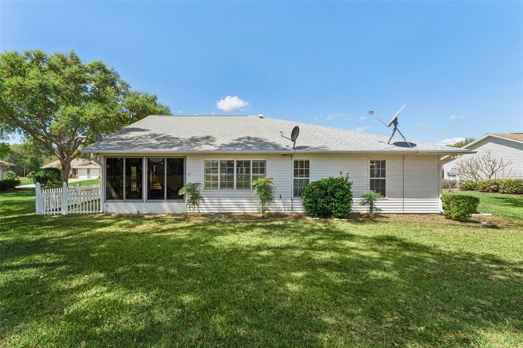 27217 Racquet Circle Leesburg, FL 34748 - Photo 35 of 90 a front view of a house with a garden and porch
