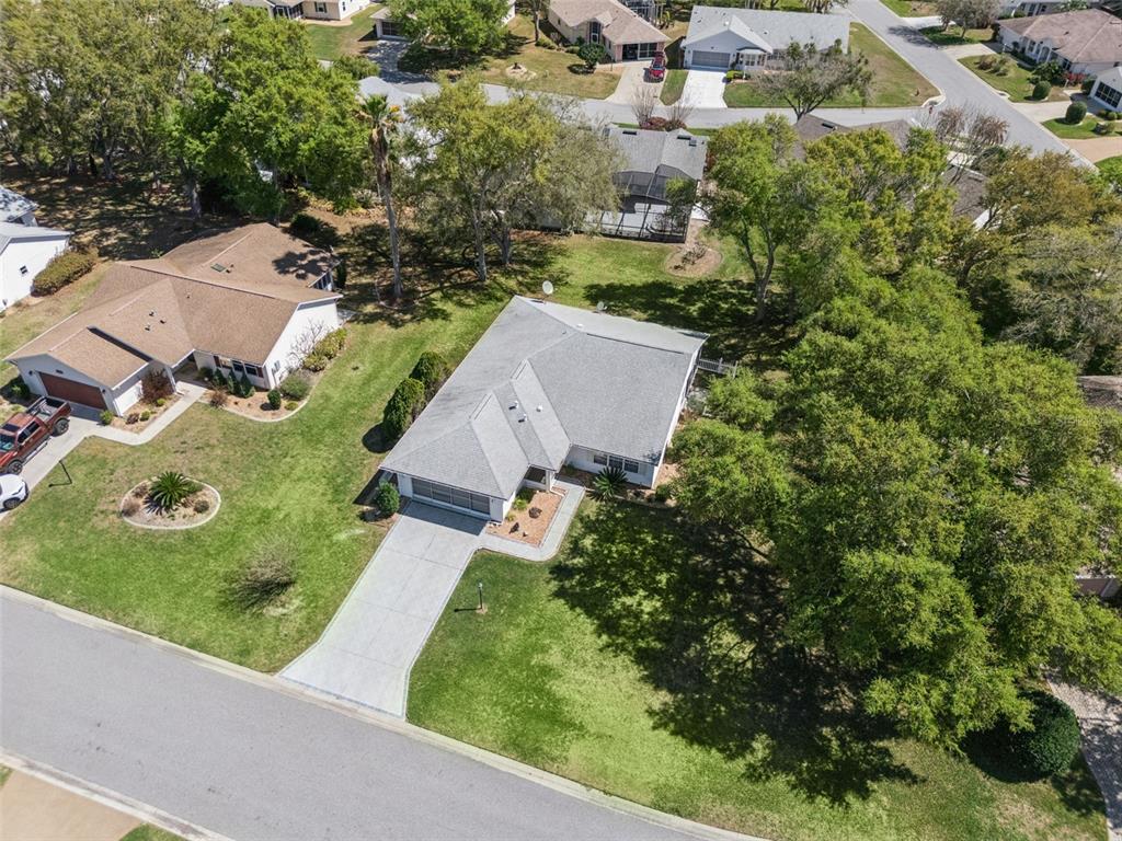 27217 Racquet Circle Leesburg, FL 34748 - Photo 38 of 90 an aerial view of a house with garden space and street view