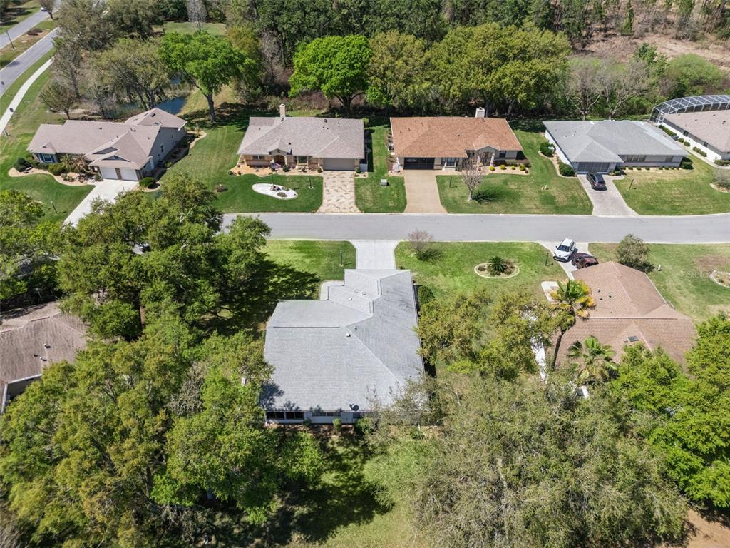 27217 Racquet Circle Leesburg, FL 34748 - Photo 40 of 90 an aerial view of residential house with outdoor space and trees all around