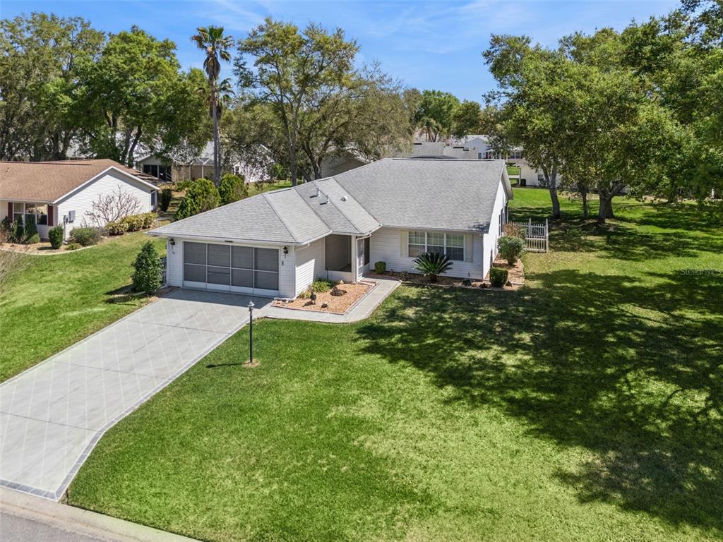 27217 Racquet Circle Leesburg, FL 34748 - Photo 4 of 90 a aerial view of a house with swimming pool and garden
