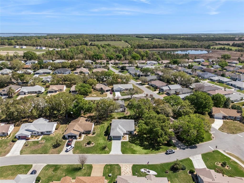 27217 Racquet Circle Leesburg, FL 34748 - Photo 43 of 90 an aerial view of residential houses with outdoor space and trees