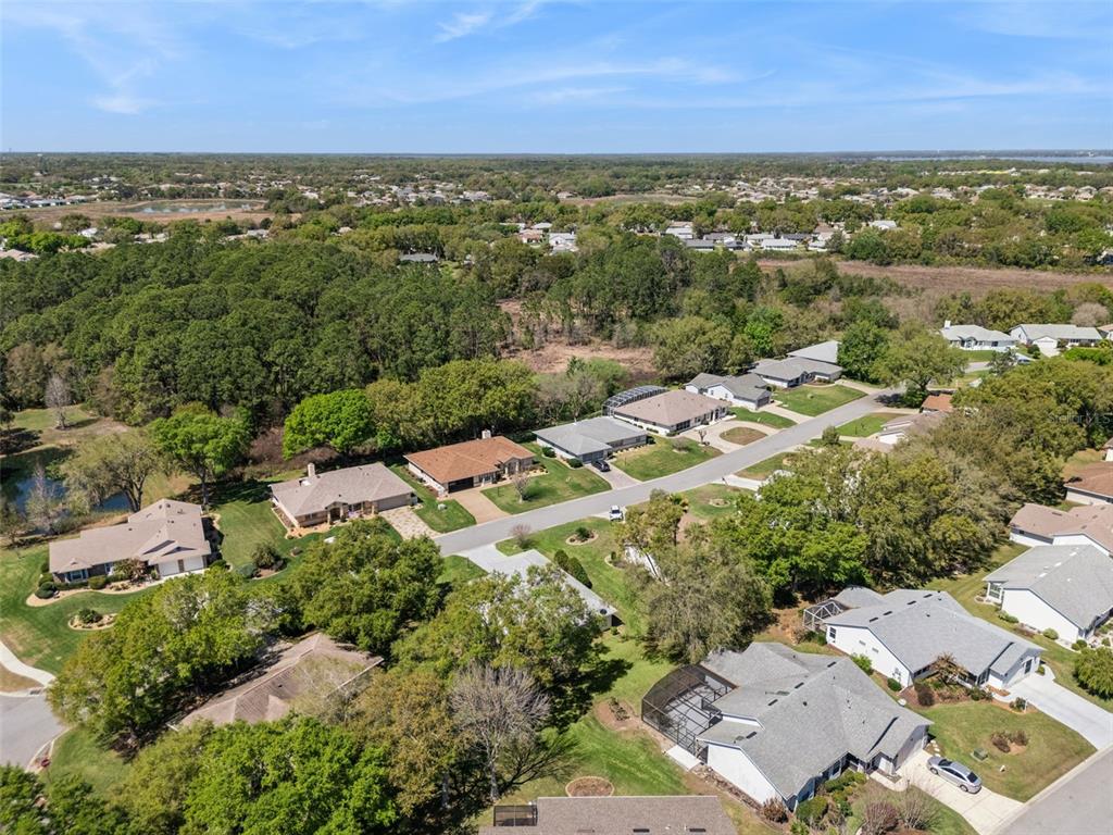 27217 Racquet Circle Leesburg, FL 34748 - Photo 45 of 90 an aerial view of residential houses with outdoor space and ocean view