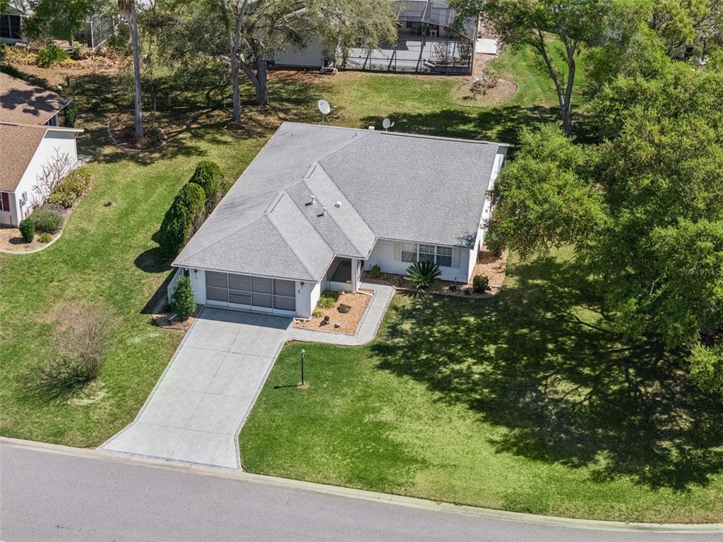 27217 Racquet Circle Leesburg, FL 34748 - Photo 6 of 90 an aerial view of a house with a yard basket ball court and outdoor seating