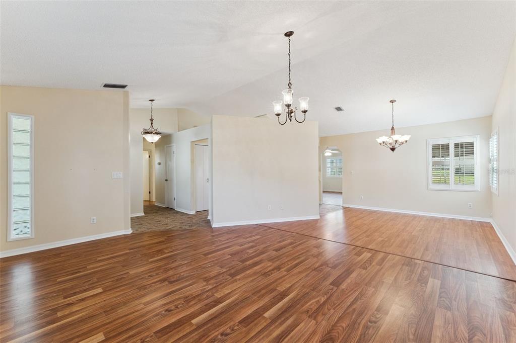 27217 Racquet Circle Leesburg, FL 34748 - Photo 7 of 90 a view of empty room with wooden floor and window