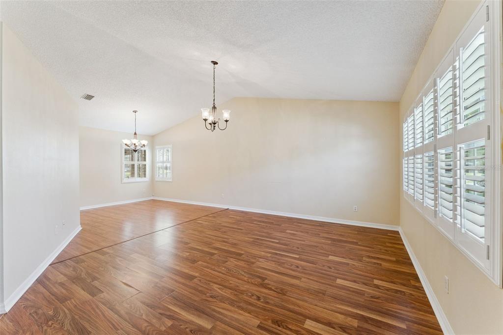 27217 Racquet Circle Leesburg, FL 34748 - Photo 8 of 90 wooden floor in an empty room with a window
