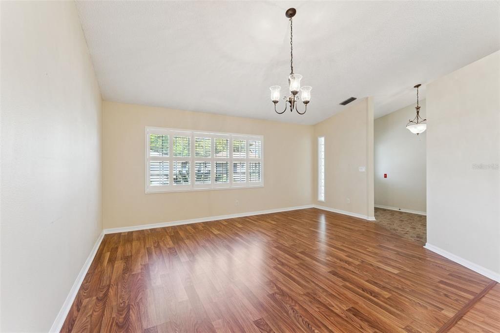27217 Racquet Circle Leesburg, FL 34748 - Photo 9 of 90 a view of an empty room with wooden floor and a window